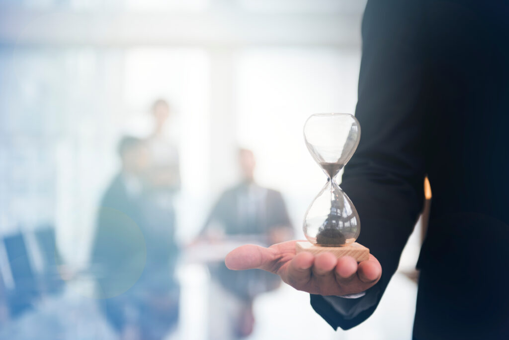 Businessman holding an hour glass